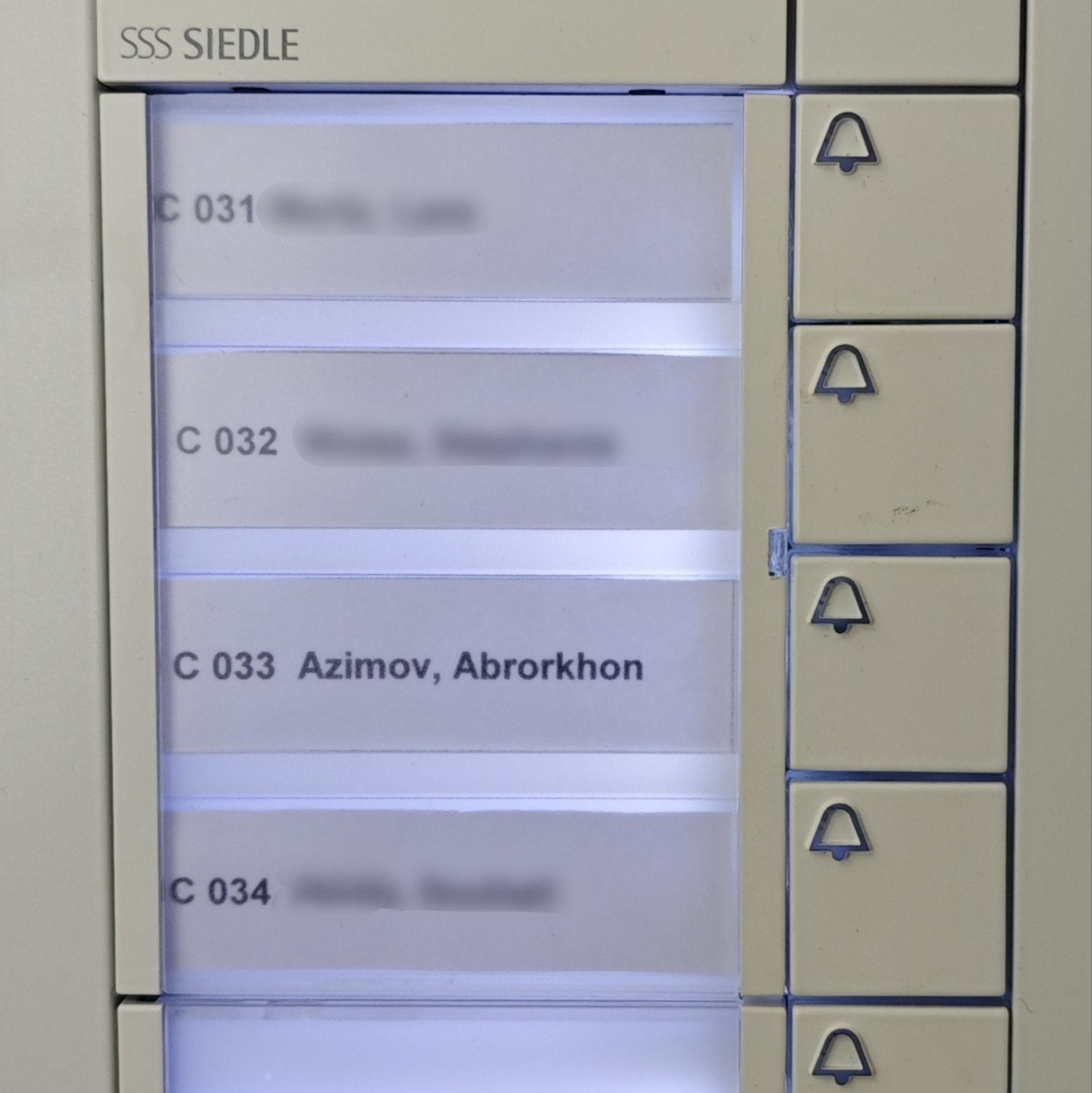 A clear, close-up example of a readable internal intercom nameplate.